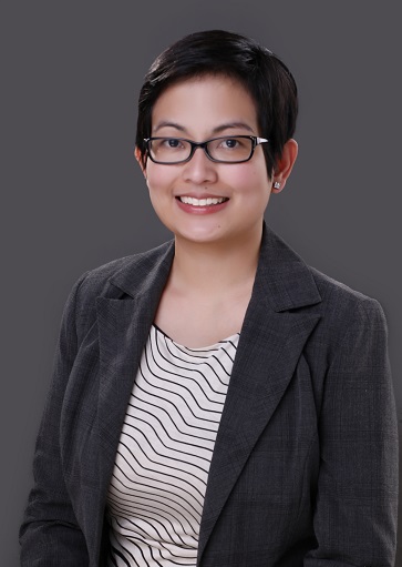 Prof. Cielo Magno smiling, wearing glasses and a dark blazer
